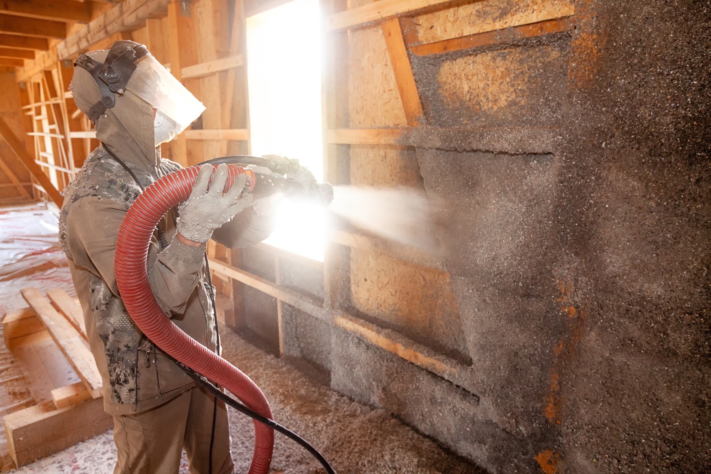 Blown Cellulose Insulation Being Applied To New Construction House
