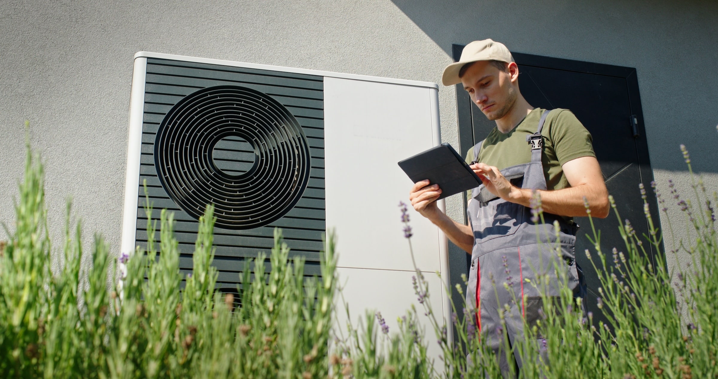 Technician reviewing heat pump performance on tablet device