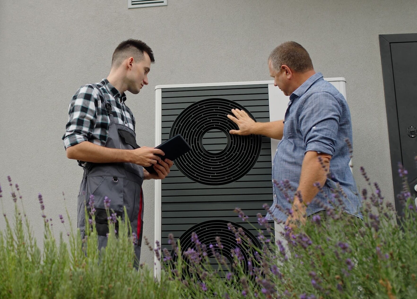 HVAC Contractor Talking With Homeowner About Installed Heat Pump